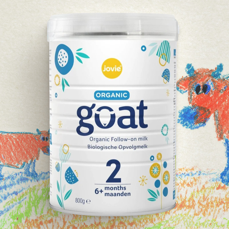 Jovie Organic Goat milk powder container with colorful cow illustrations in the background