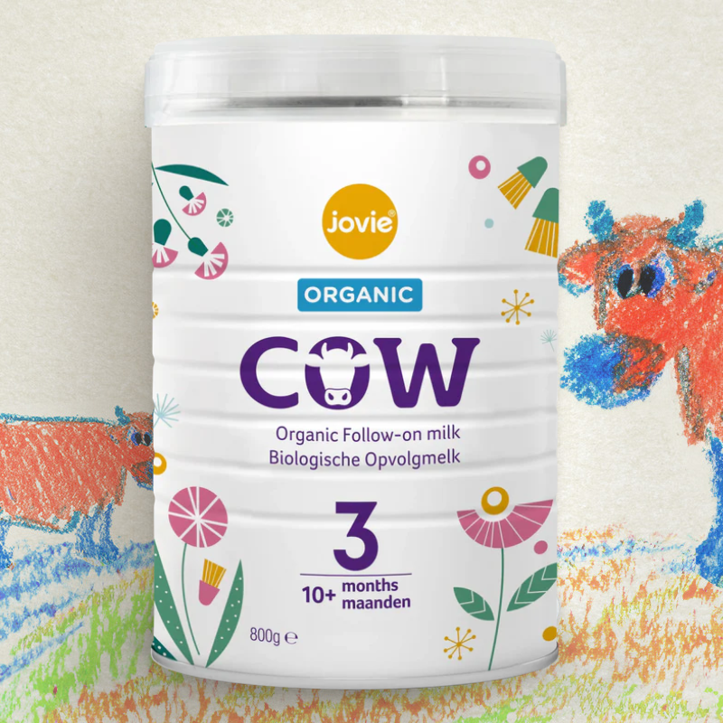 Jovie Organic Cow milk powder container with colorful cow illustrations on a light background