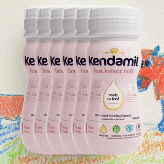 Multiple containers of Kendamil first infant milk on a colorful background