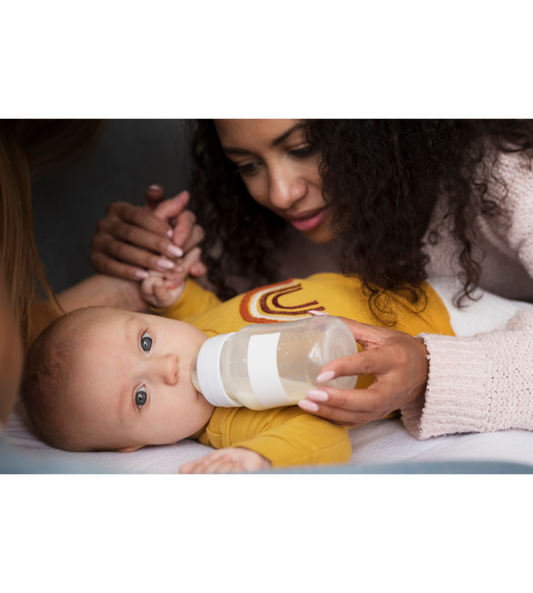 Mother bottle feeding her baby with organic baby formula