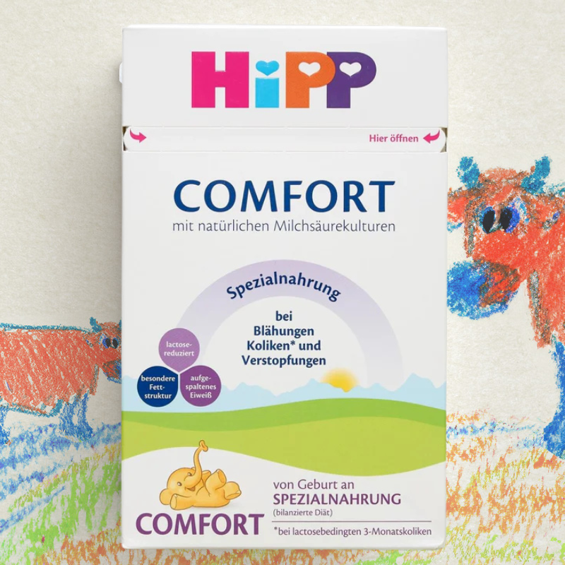 Hipp Comfort baby formula packaging with colorful illustrations on a textured background