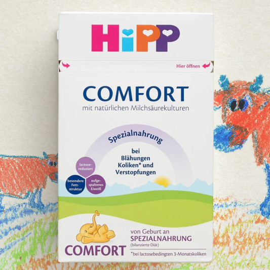 Hipp Comfort baby formula packaging with colorful illustrations on a textured background