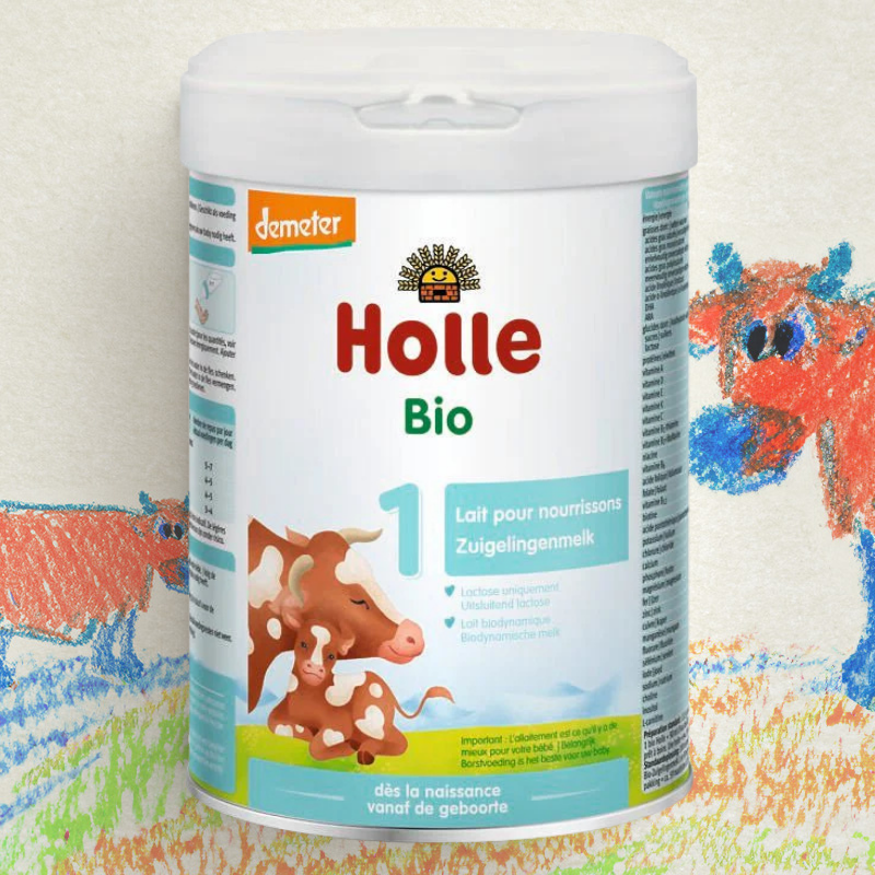 Holle Bio baby formula container with cow illustration on a colorful background