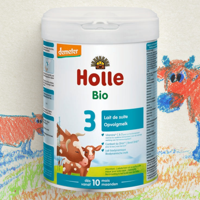 Holle Bio baby formula container with cow illustrations on a colorful background