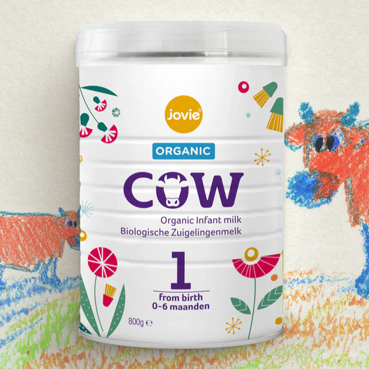 Jovie Organic Cow infant milk powder container with colorful illustrations on a light background