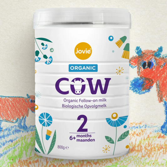 Jovie Organic Cow milk powder container with colorful cow illustrations on a light background
